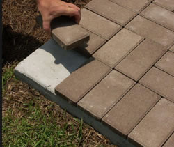 Installing thin pavers over concrete.