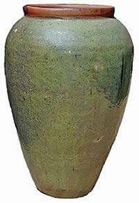 A tall green jar with a brown rim