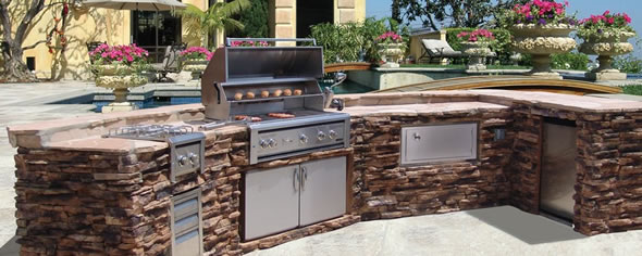 Beautiful outdoor grill island with stone facade by Luxor.