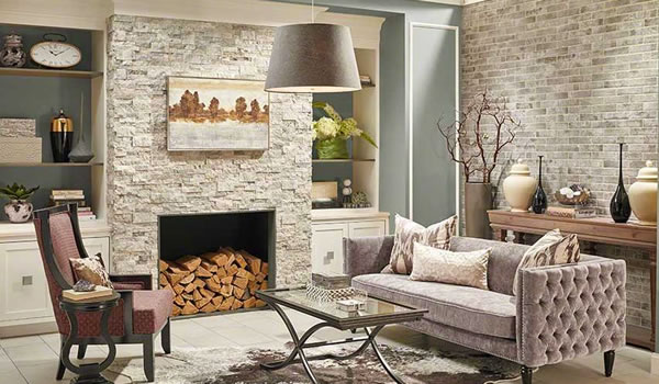 A picture an inside fireplace with a stone veneer.